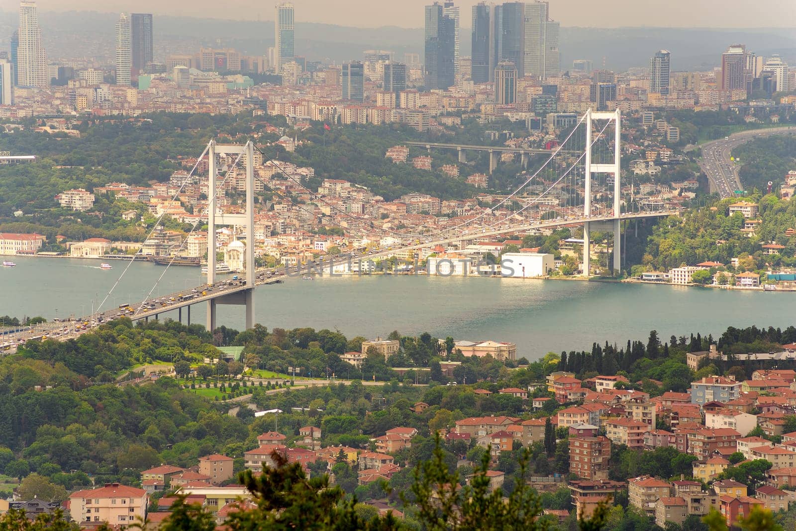 Aerial sunset shot of Istanbul city from Camlica park overlooking Bosphorus strait, with Bosphorus Bridge, or Bogazici Koprusu, connecting Europe and Asia, Istanbul, Turkey