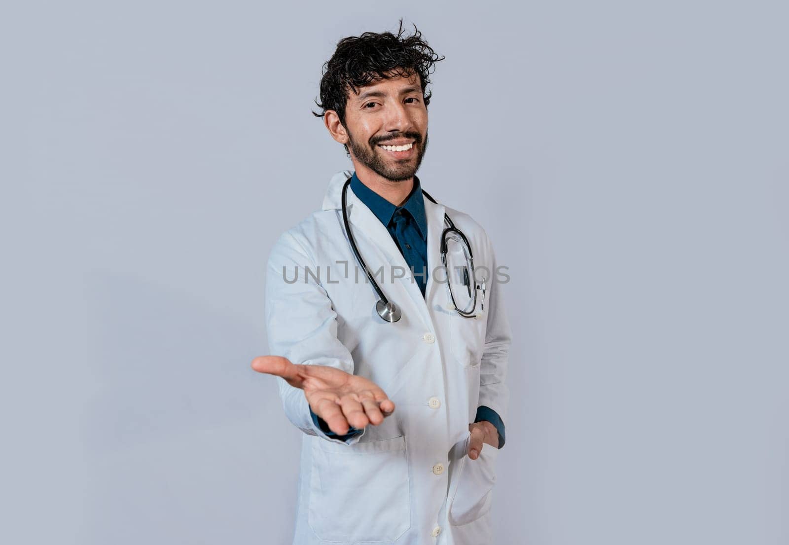 Smiling doctor extending hand in welcome. Young doctor extending hand to camera, Smiling doctor extending hand isolated