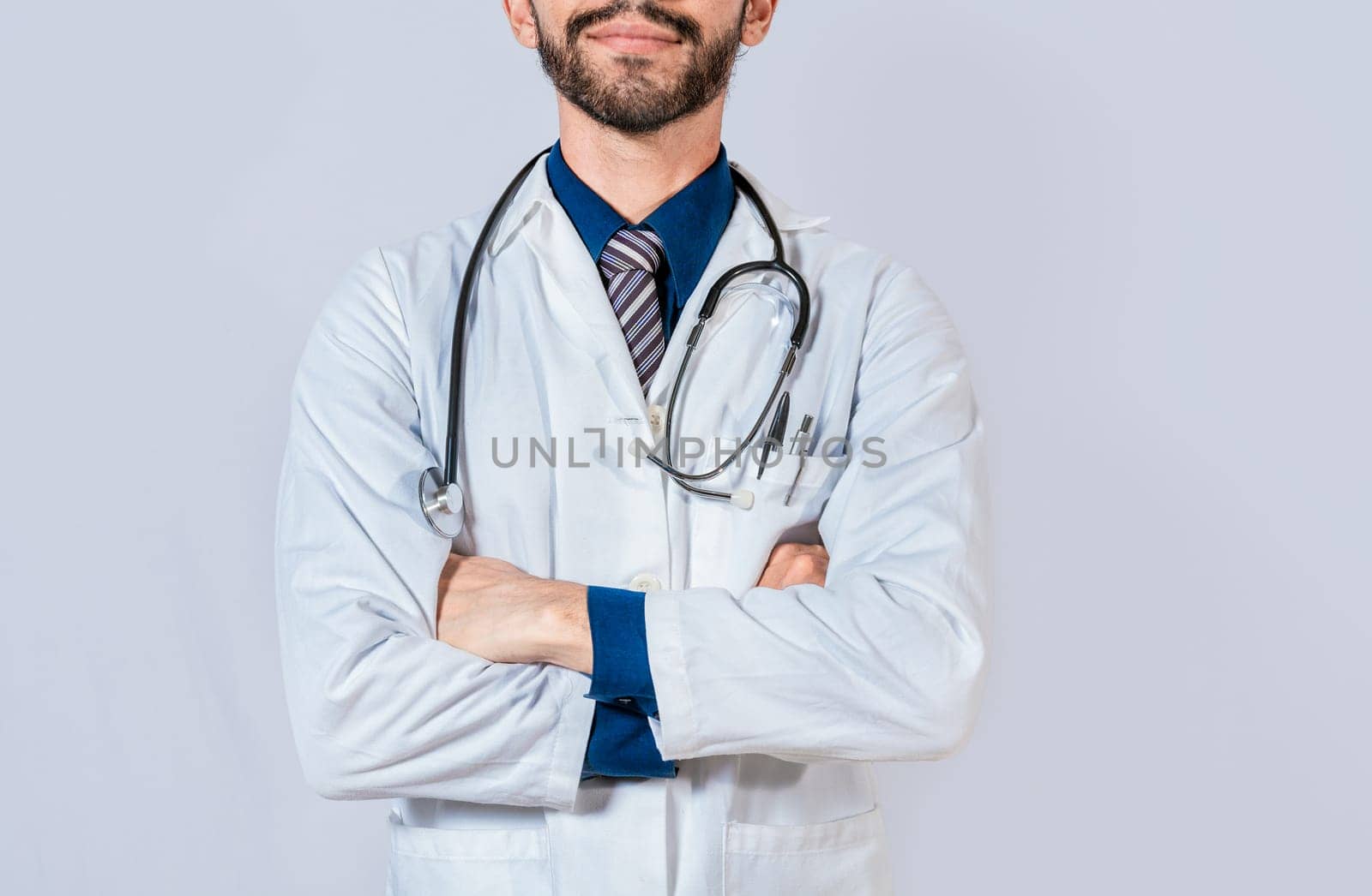 Unrecognizable doctor with crossed arms on isolated background. Young doctor with crossed arms isolated