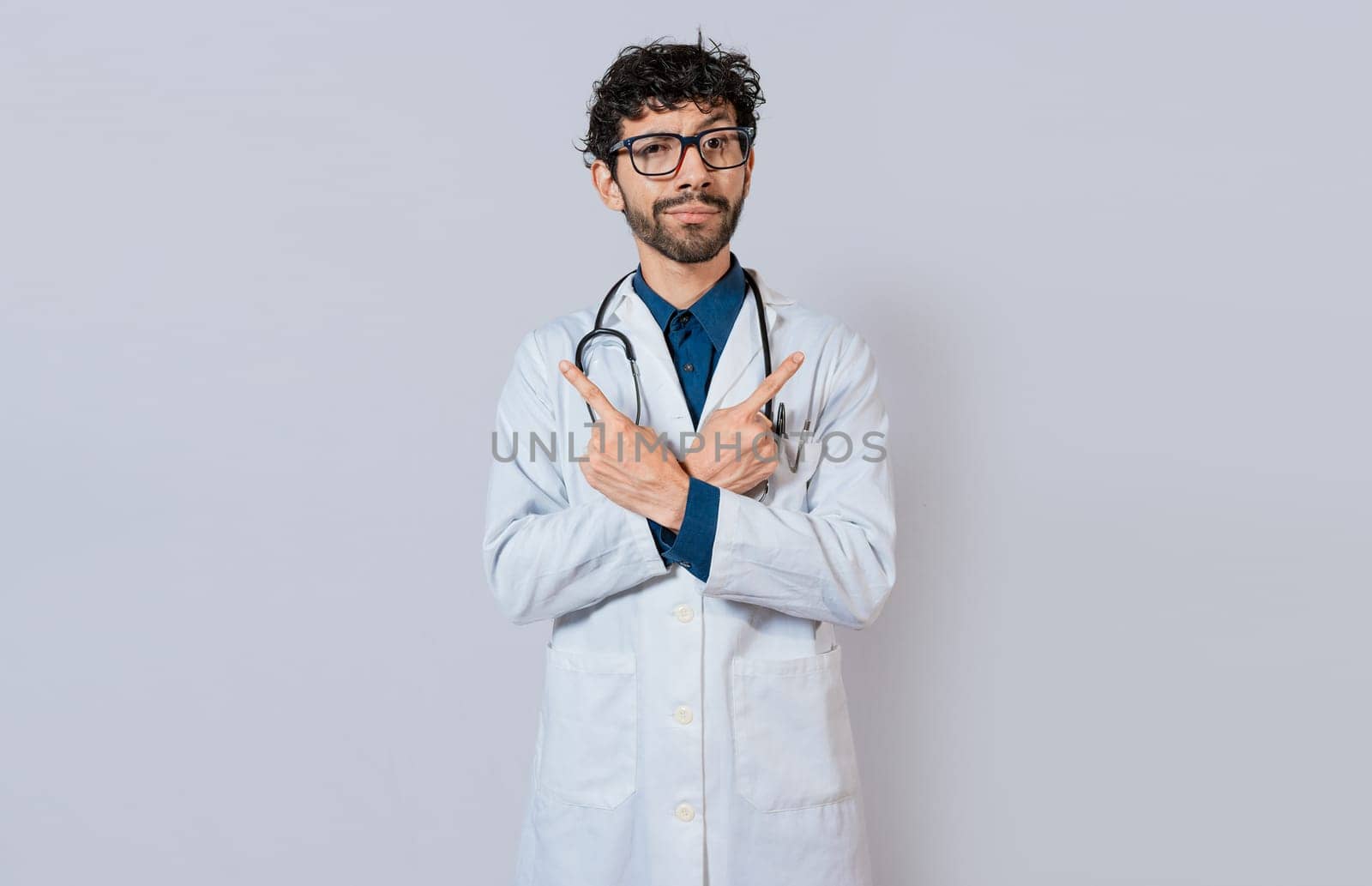 Doctor pointing to both sides isolated. Bearded doctor pointing to both sides on isolated background. Doctor pointing at an advertising space with both hands
