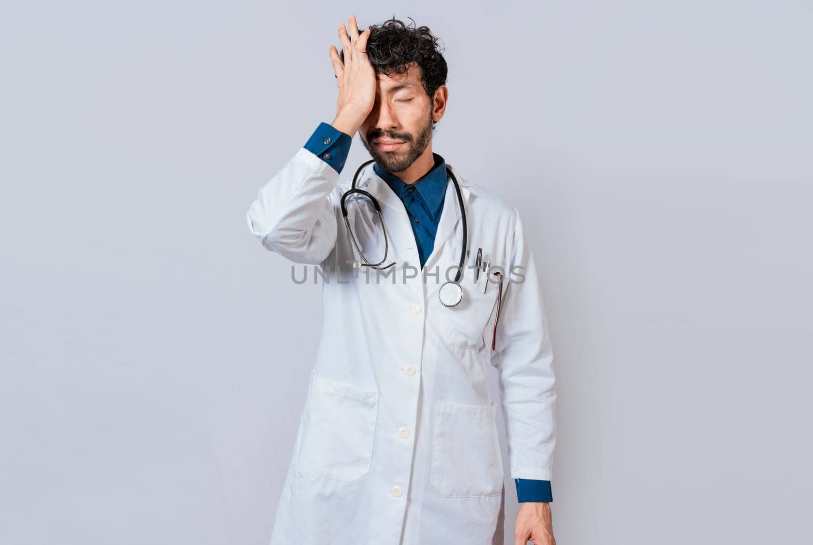 Tired doctor with hand on forehead, Exhausted doctor with hand on forehead isolated