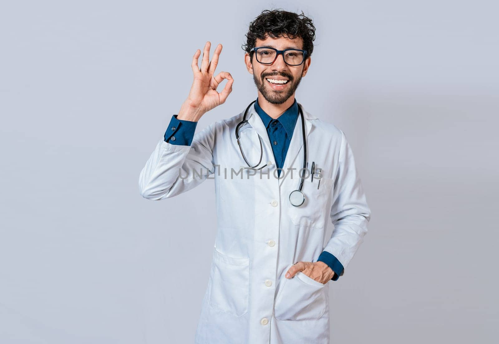 Happy doctor gesturing approval isolated. Handsome doctor approving and recommending isolated