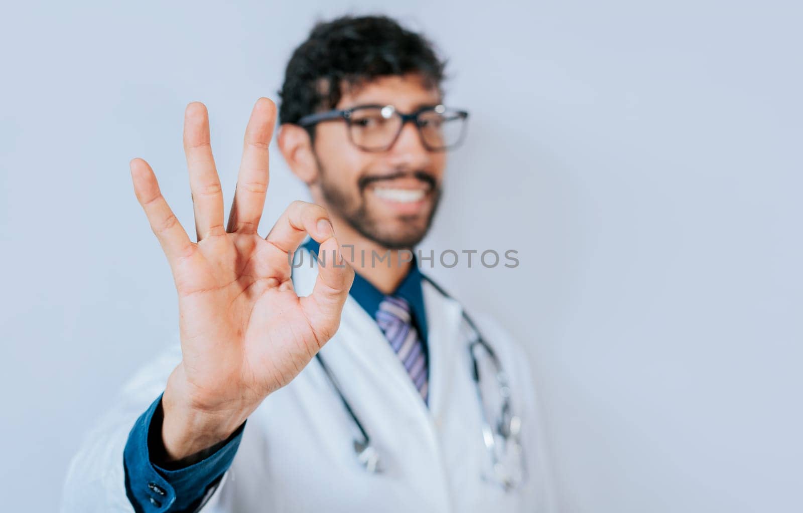 Happy doctor gesturing approval isolated. Handsome doctor approving and recommending isolated