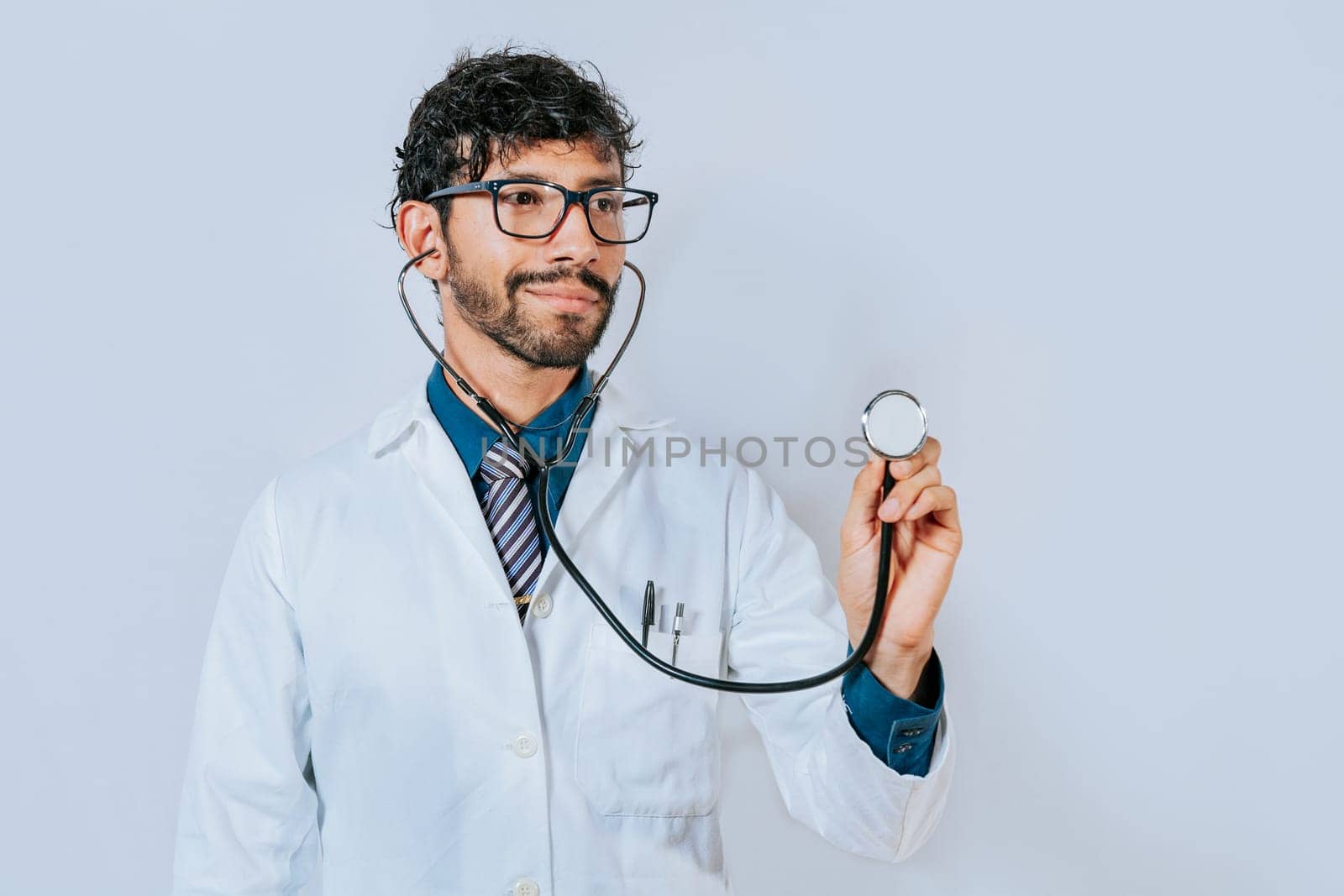 Portrait of male doctor holding isolated. handsome doctor holding stethoscope on white background