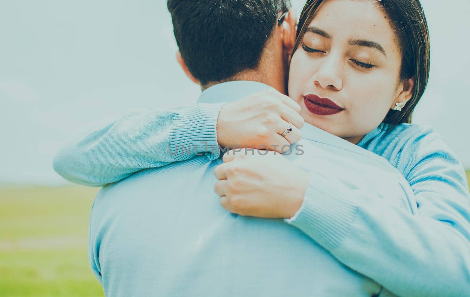 Close up of a girl giving a loving hug, Concept of a couple lovingly embracing each other in the field, close up of a girl giving a hug of love and comfort