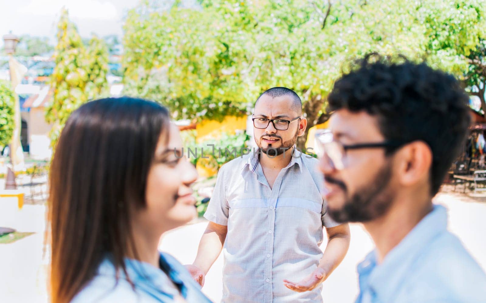 Man discovering his cheating girlfriend with another man outdoor, Boyfriend discovering his girlfriend's infidelity outdoors. Man looking at his cheating girlfriend with another man outdoors