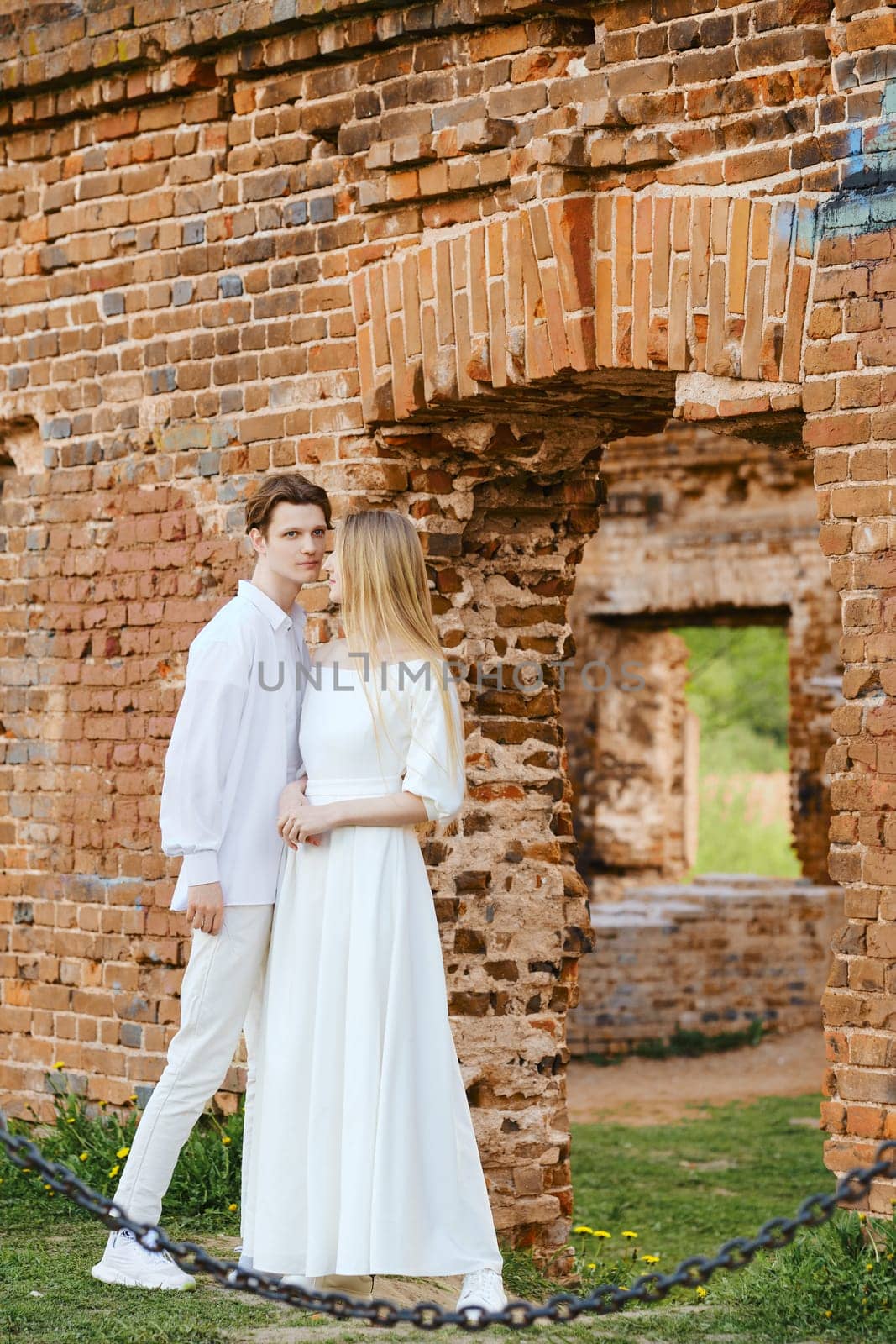 Young couple exploring old ruins of a castle