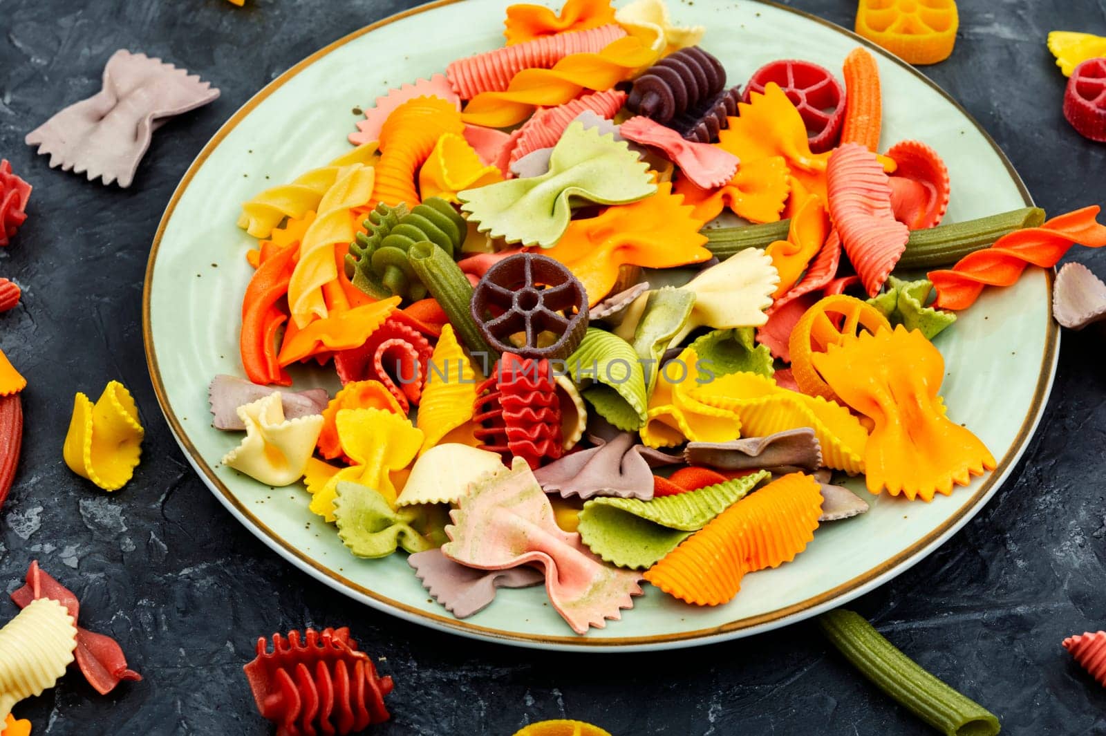 Colorful italian raw pasta or macaroni for kids.