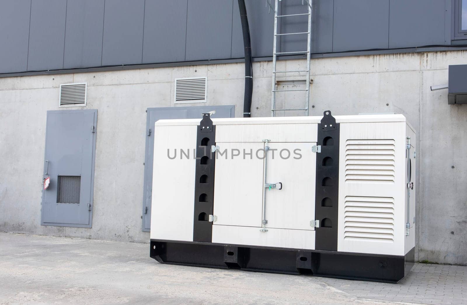Emergency, backup industrial generator for uninterruptible power supply, diesel installation in a white iron case. Emergency power supply