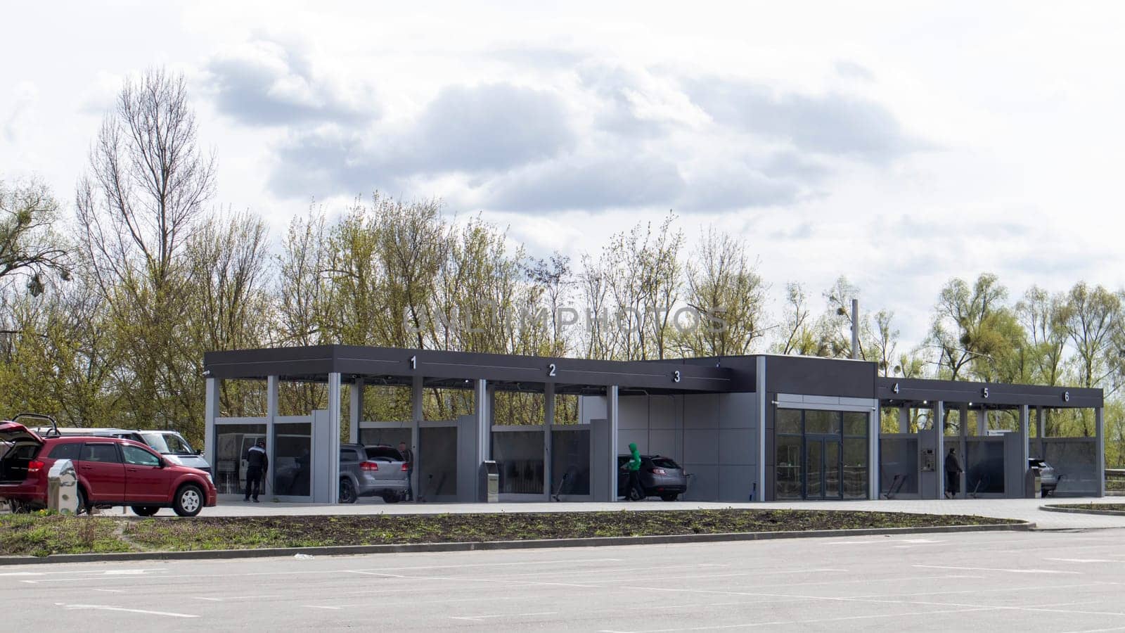 Self-service high-pressure car wash in the open air. Photo of an open self-service car wash. Manual car wash with pressurized water in a car wash outside