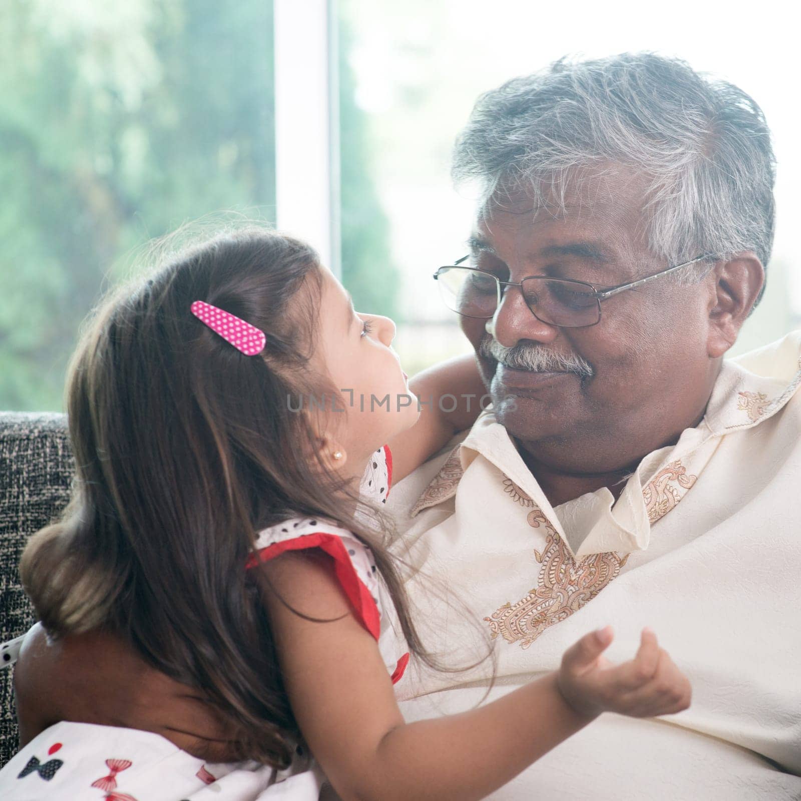 Portrait Indian family at home. Grandparent and grandchild close up face. Asian people living lifestyle. Grandfather and granddaughter.
