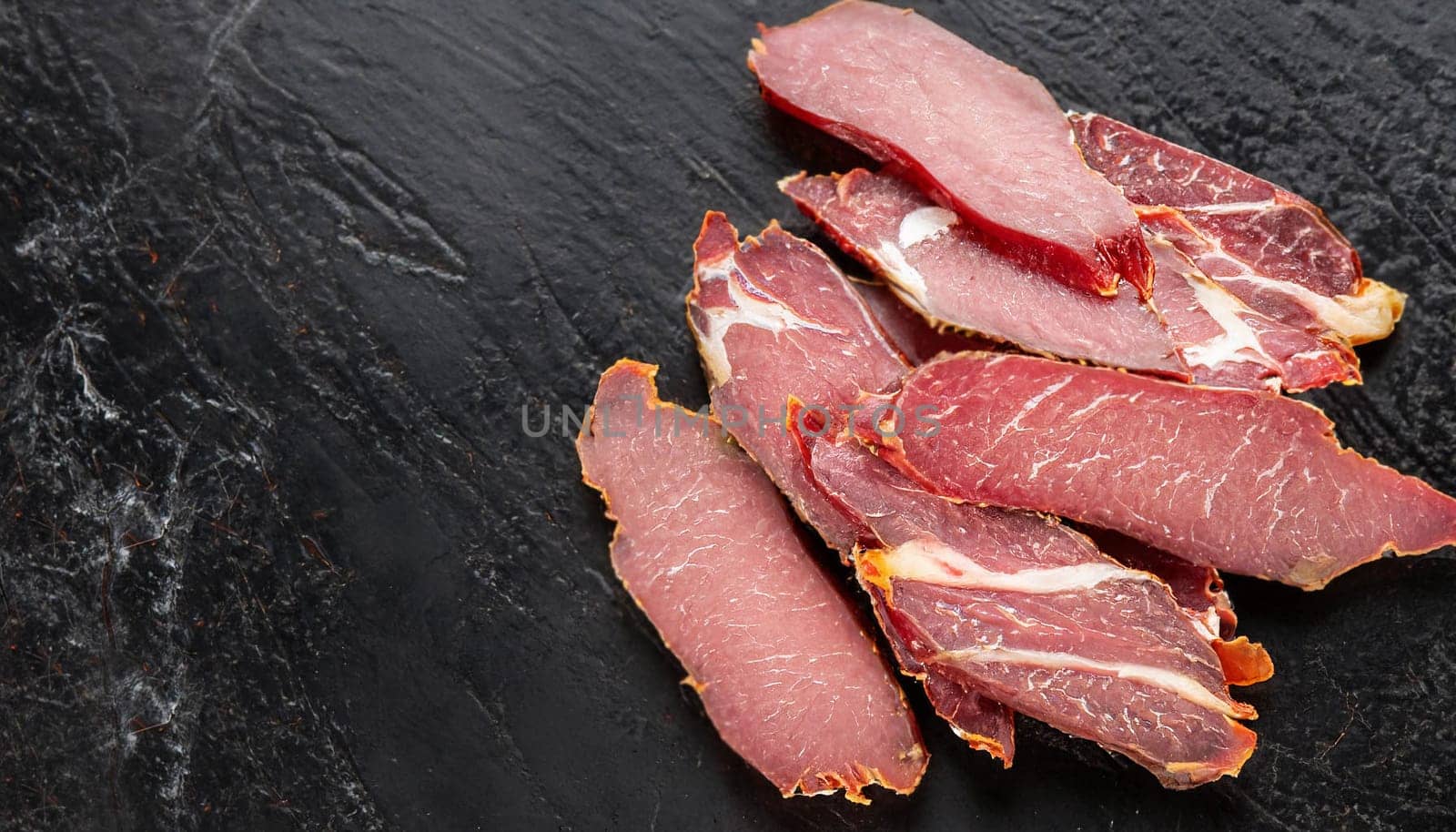 A plate of meat delicacies for beer. Craft production of meat snacks.