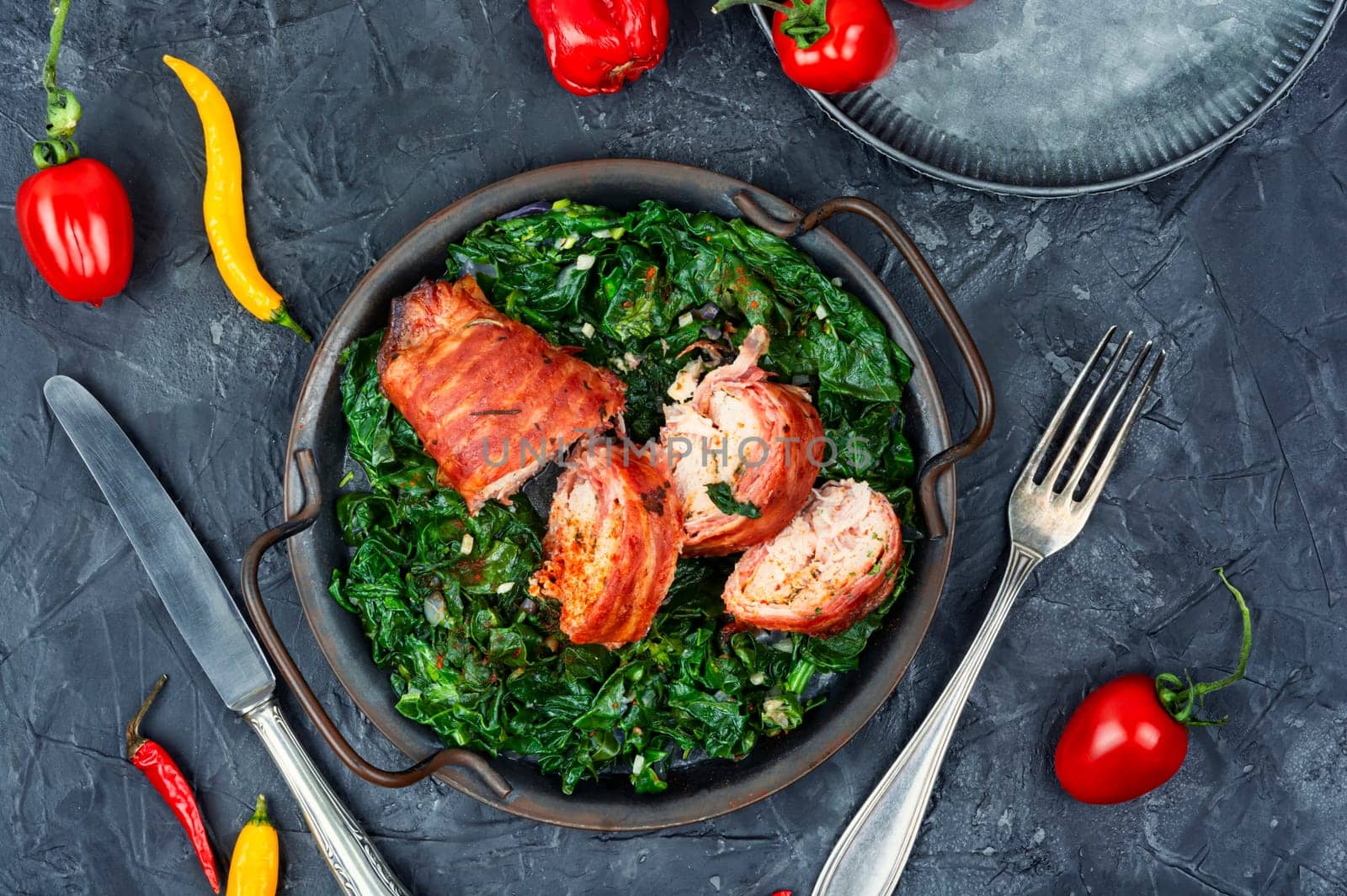 Sliced fried chicken roll with spinach garnish. Space for text