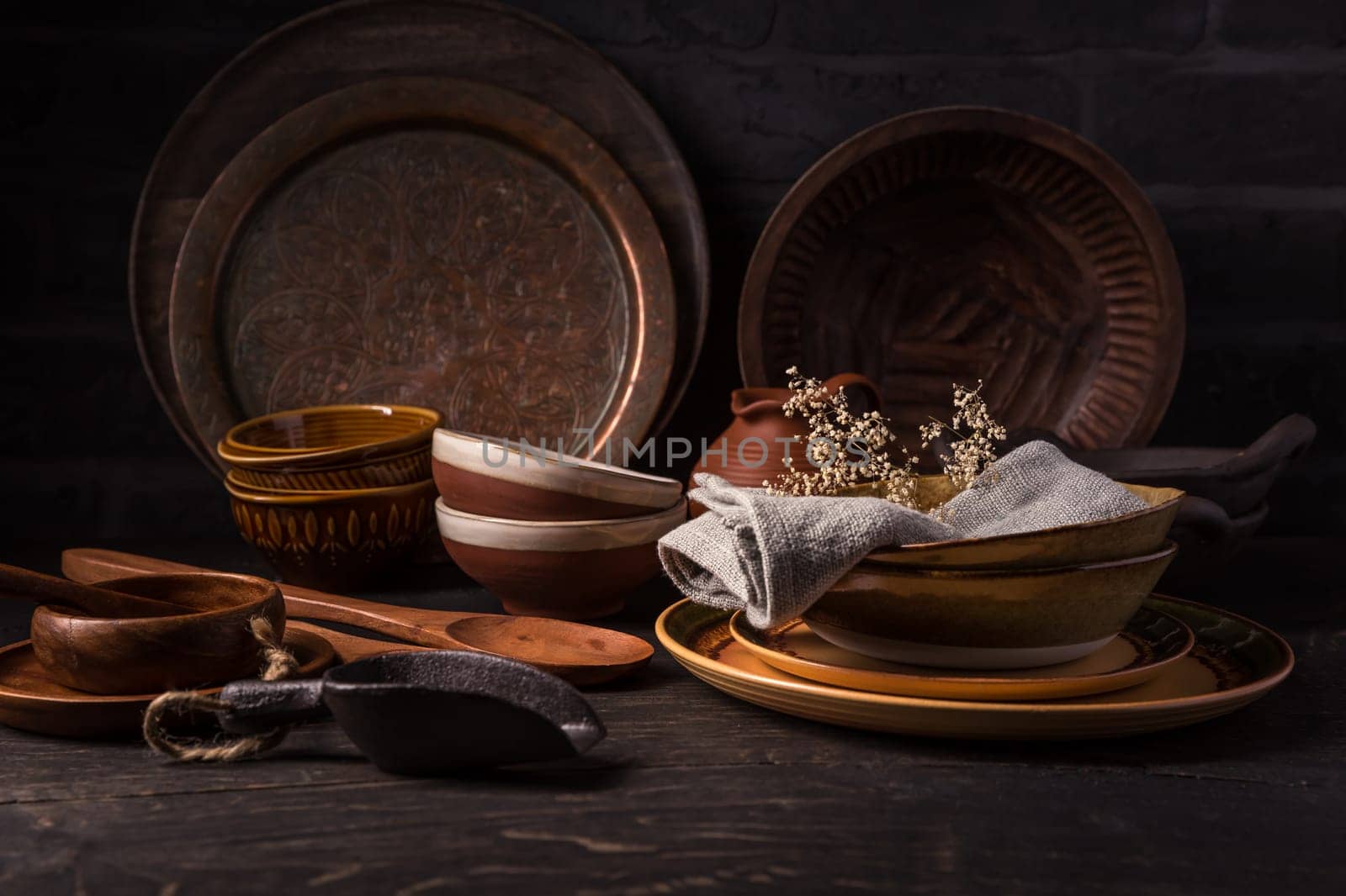 Set of kitchen ceramic and wooden tableware a table. Eco style home still life. Vintage style