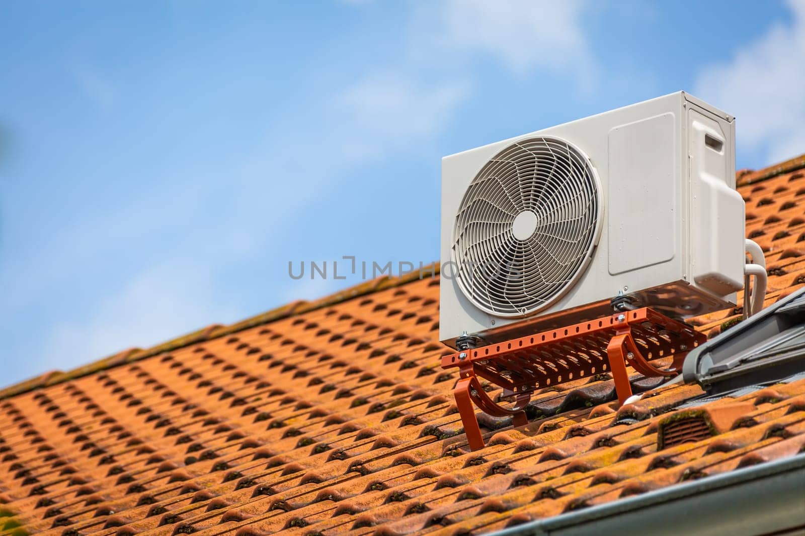 Dual inverter, combination of air conditioner compressor and heating pump, installed on a roof of family house.