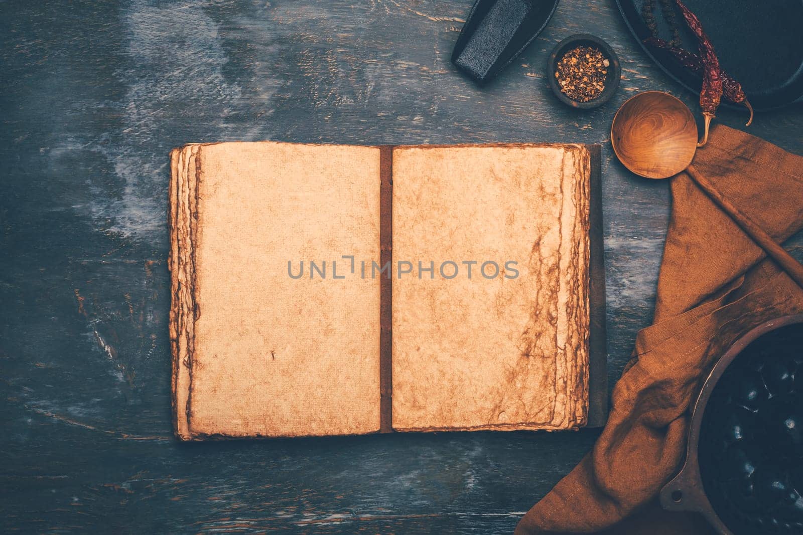 Empty menu or cookbook and kitchen utensils on wooden table, vintage style