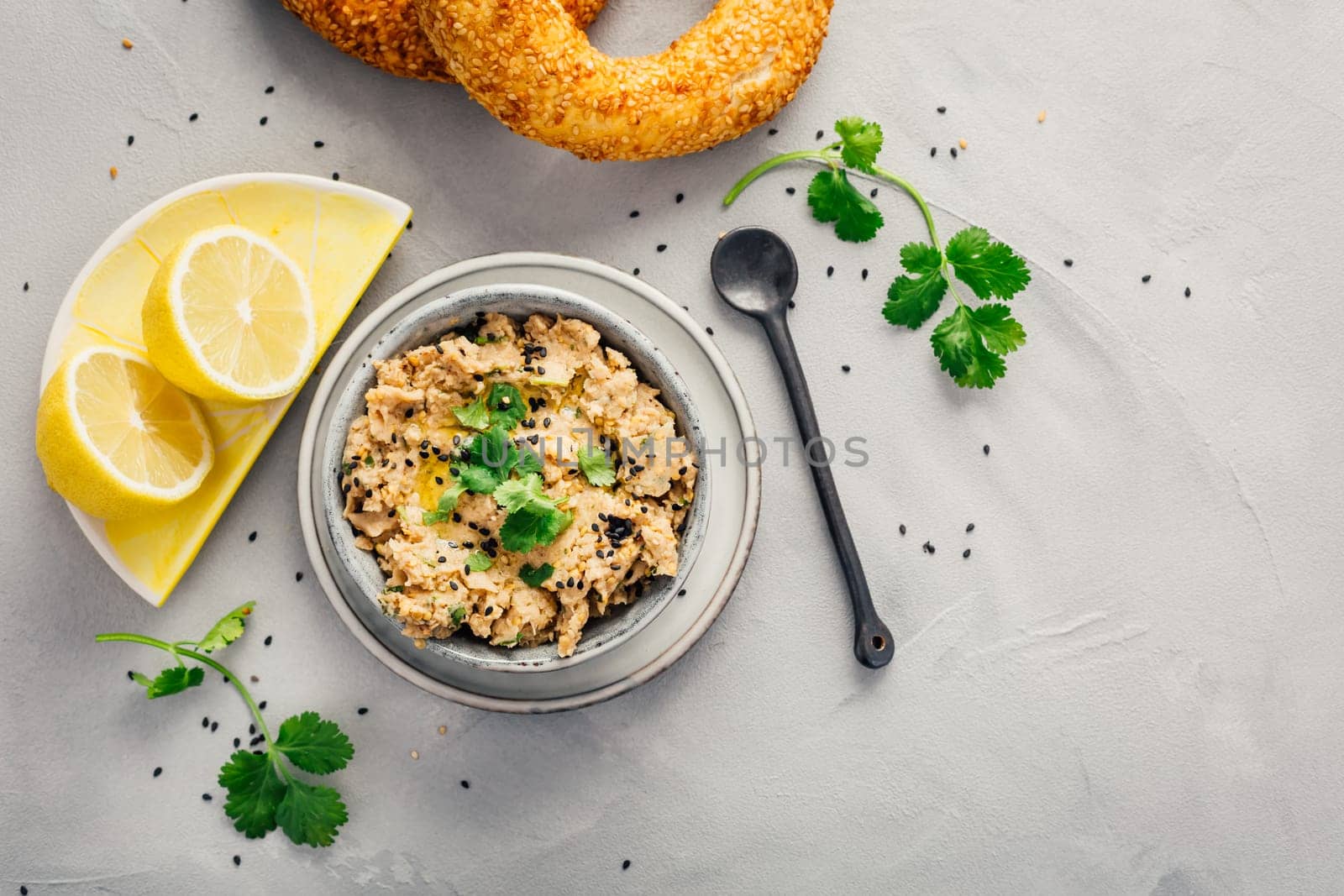 Vegan chickpea hummus spread with lemon and bagel