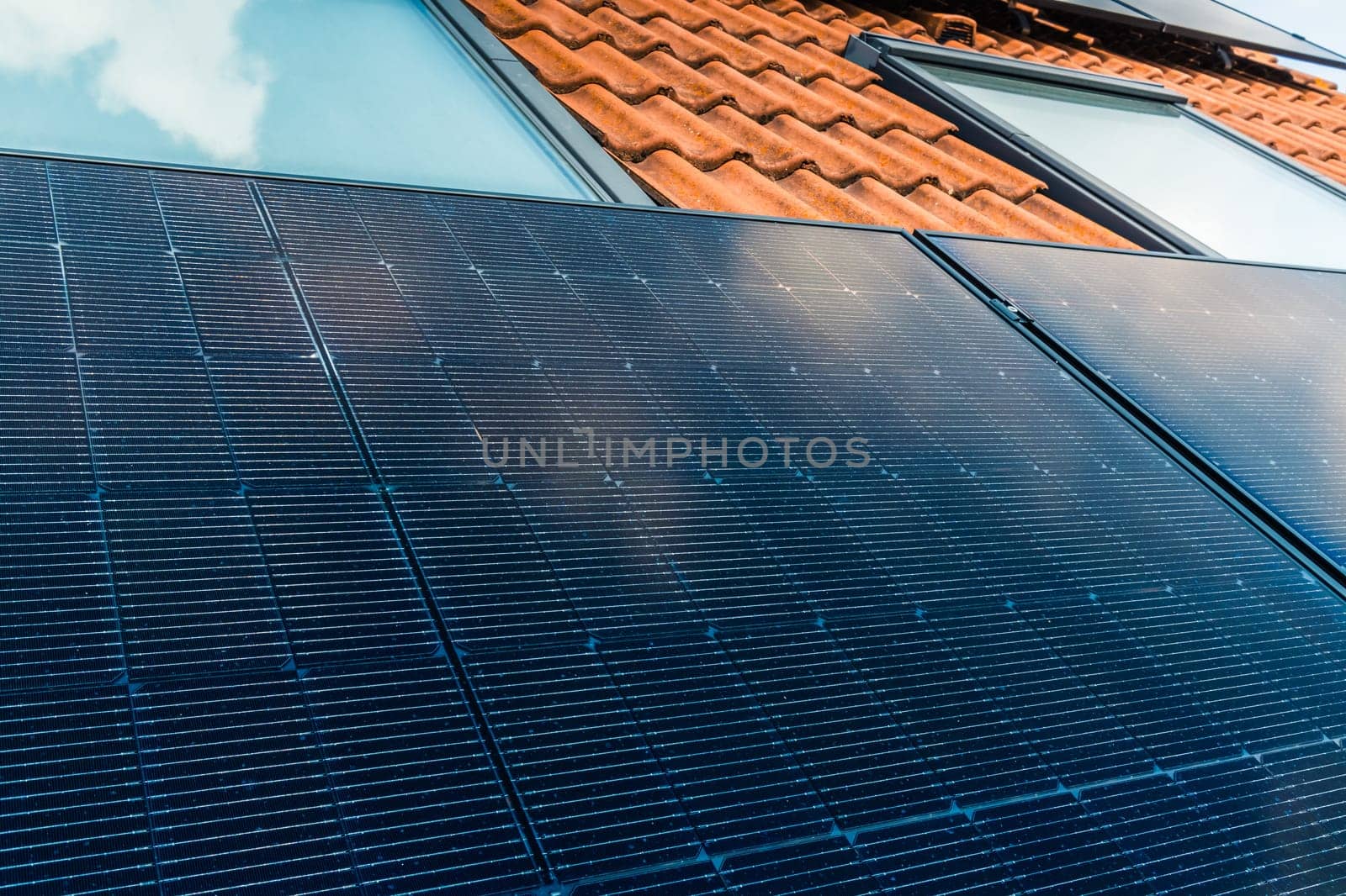 Photovoltaic panels on the roof of family house, solar panels. Environment and technology concepts.