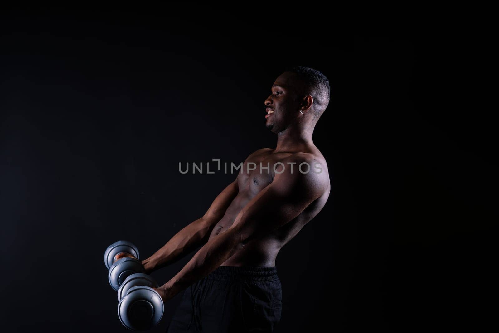 Portrait of athletic african american man topless smiling, yellow, red and black background