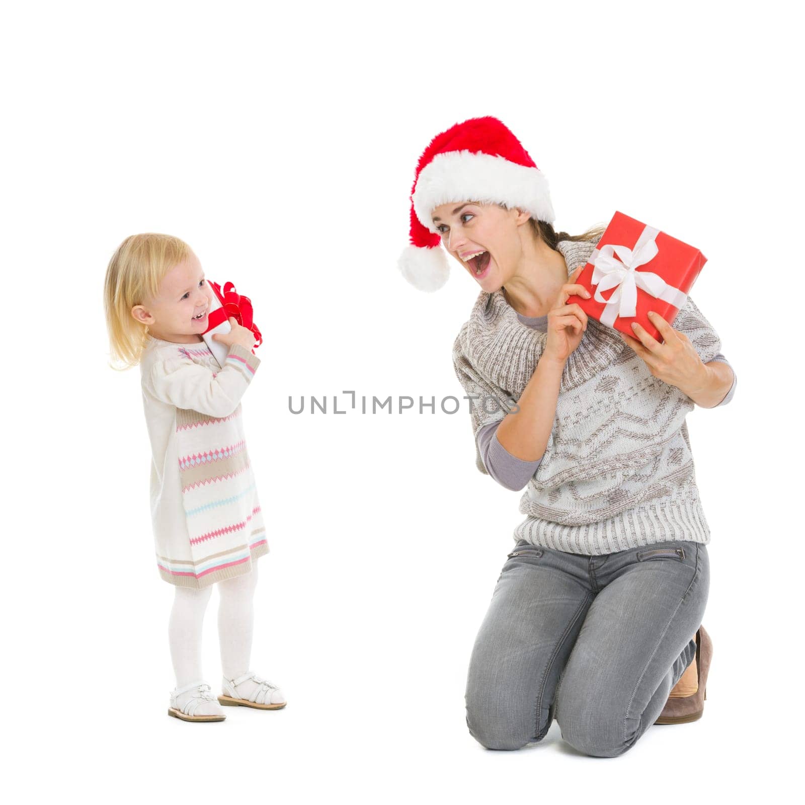 Happy mother and baby with Christmas present boxes