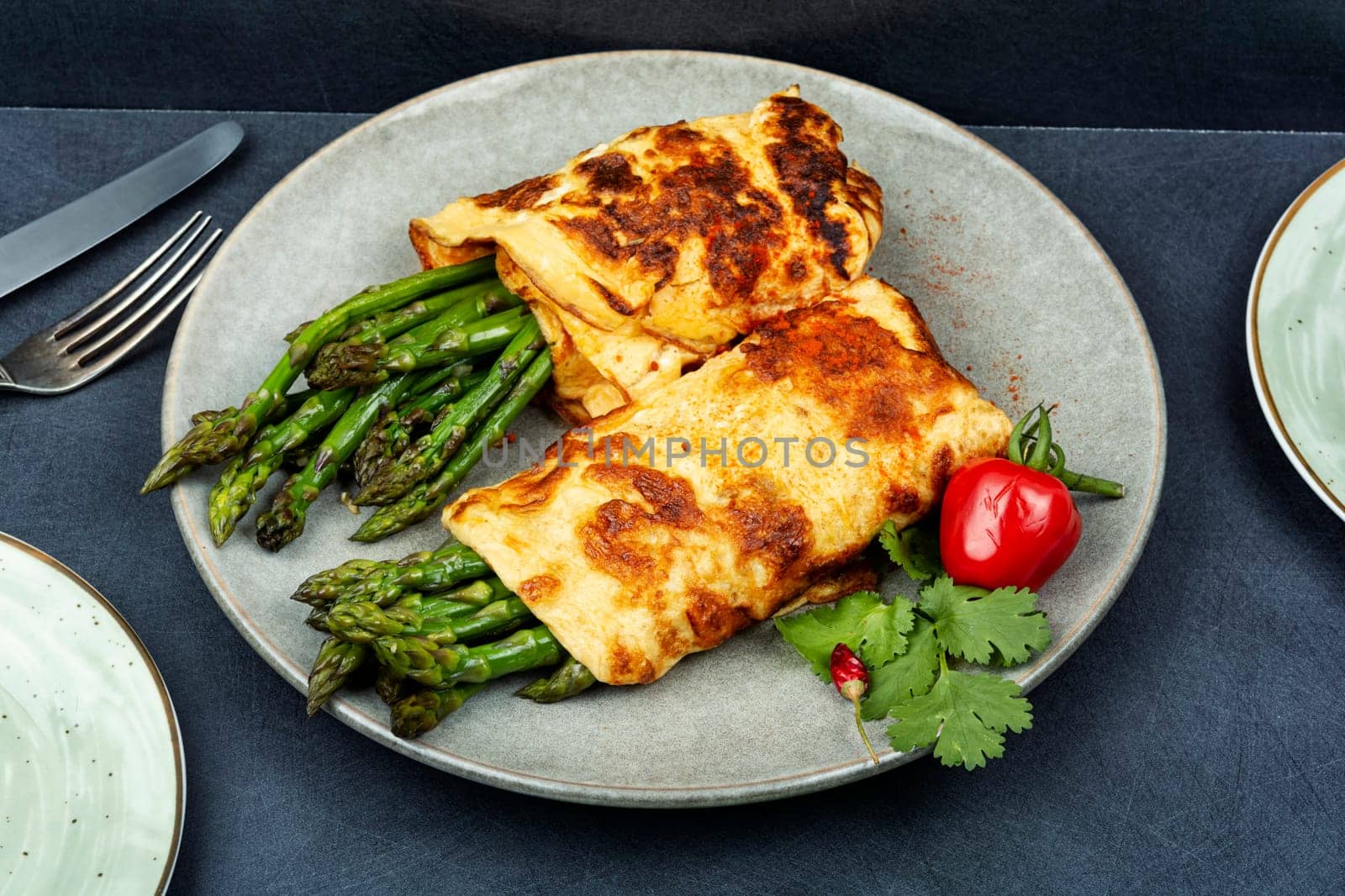 Freshly made omelette cooked with green asparagus for breakfast