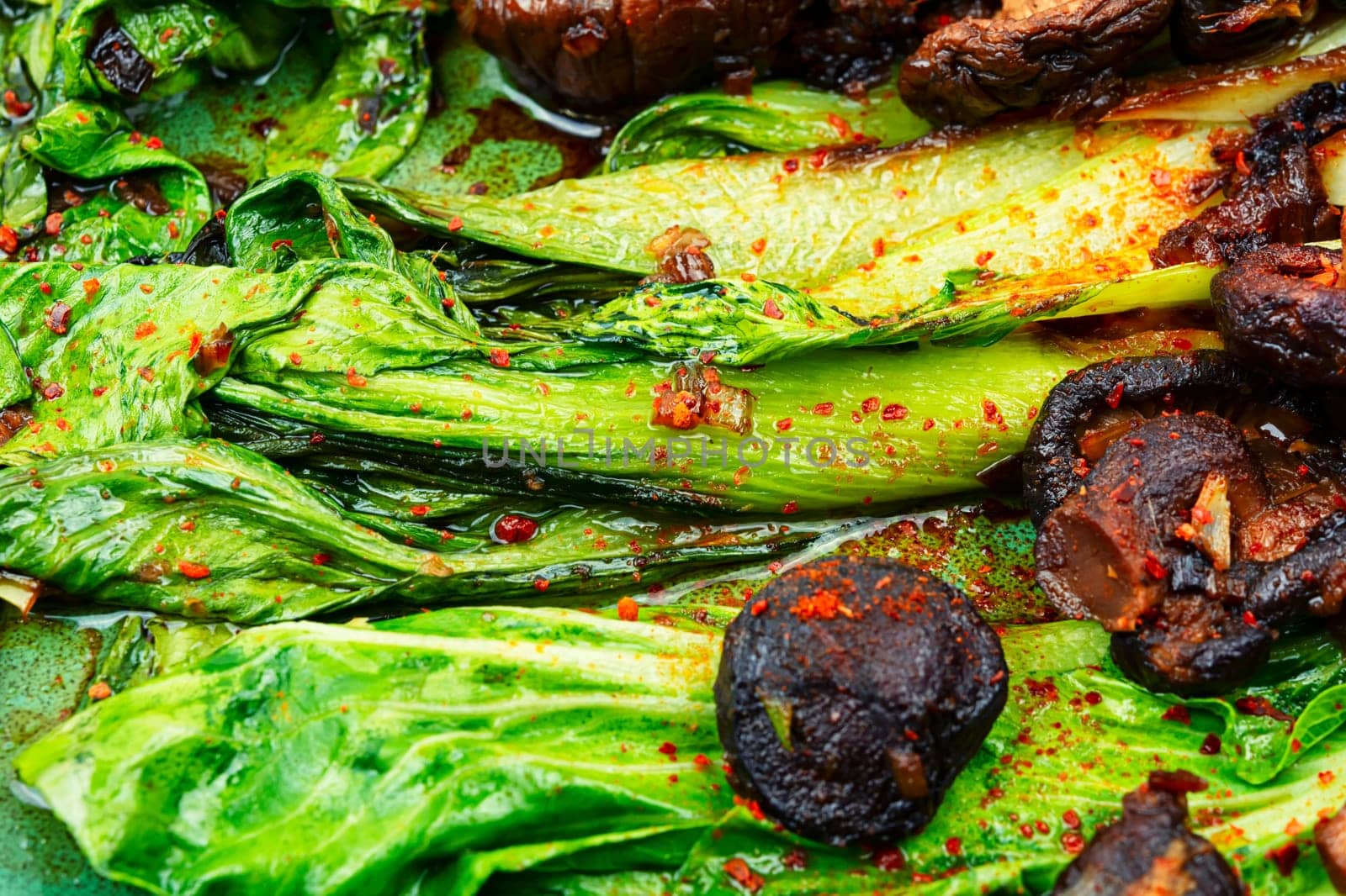 Chinese fried Pak Choi with shitake mushrooms and chopstick. Asian vegan food