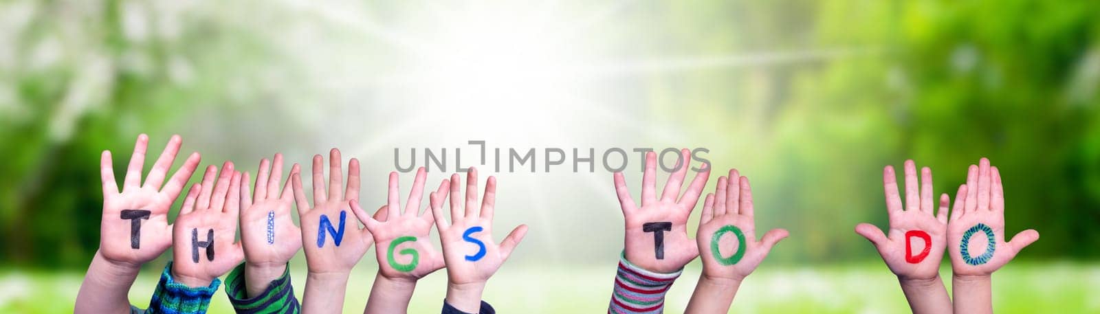 Children Hands Building Colorful English Word Things To Do. Sunny Green Grass Meadow As Background.