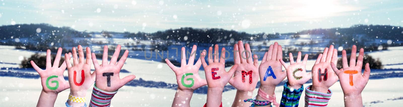 Children Hands Building Colorful German Word Gut Gemacht Means Well Done. White Winter Background With Snowflakes And Snowy Landscape.
