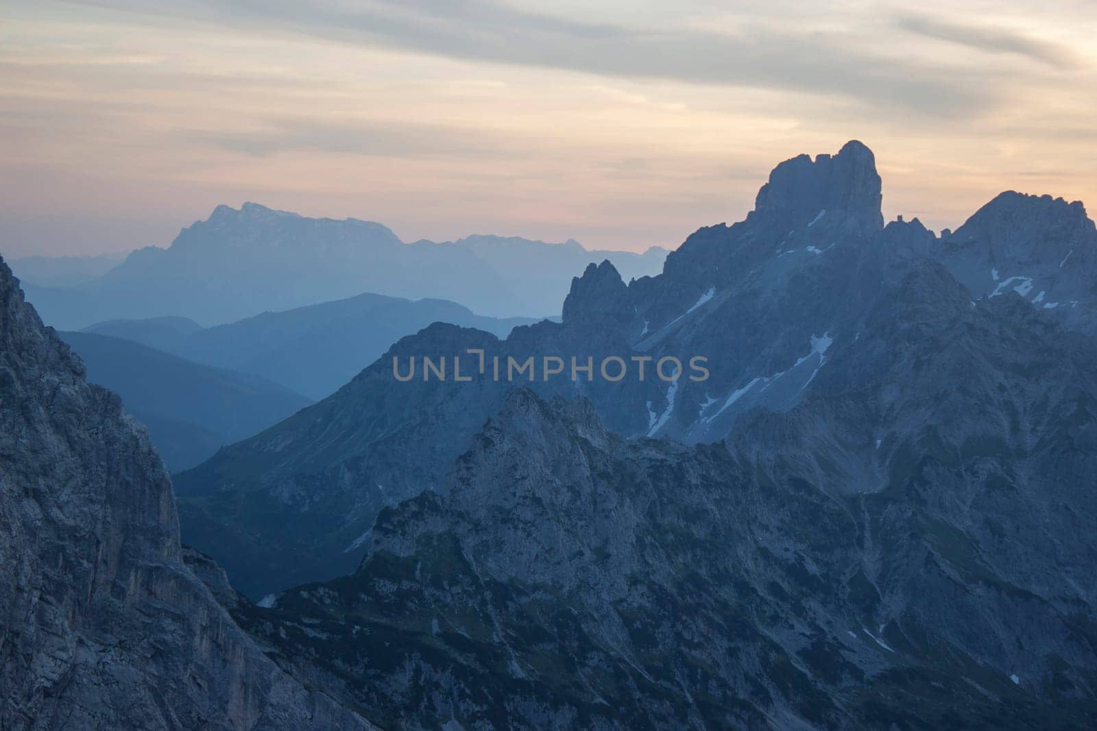 Sunset - Panorama of massive Alpine mountains. Landscape in the Austrian Alps of the Dachstein region (Styria in Austria)