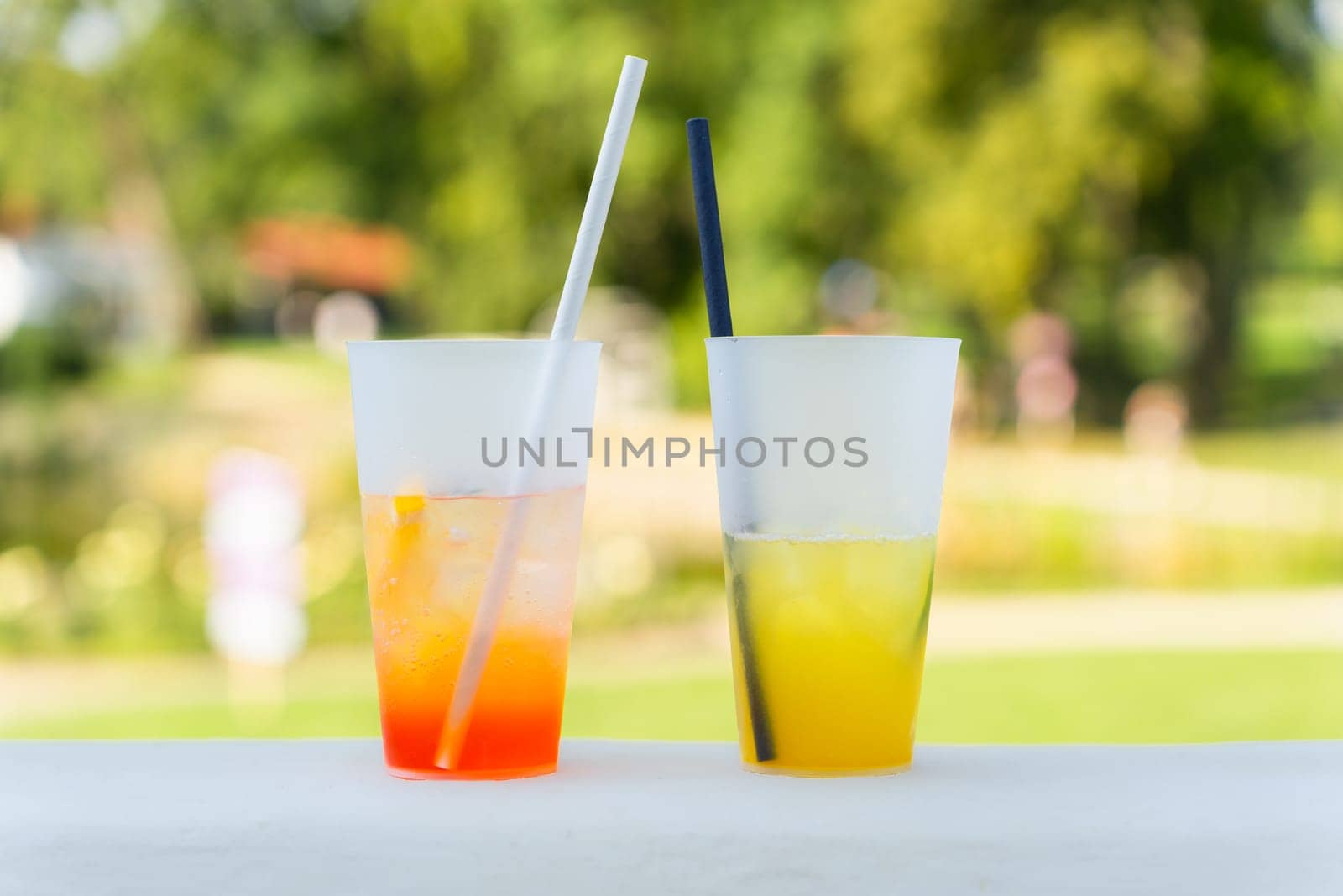 Orange cocktail Spritz and lemonade, refreshing summer drinks on the terrace in the park.