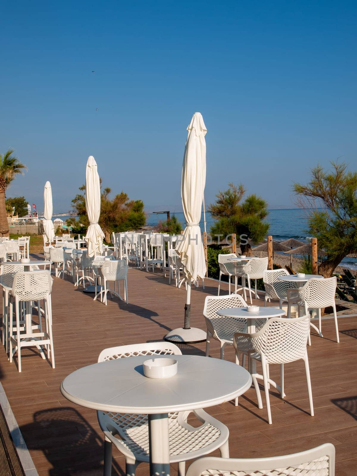 Rethymnon, Crete, Greece - June 15, 2022: Waterside cafe in sunny day in Rethymnon Crete, Greece