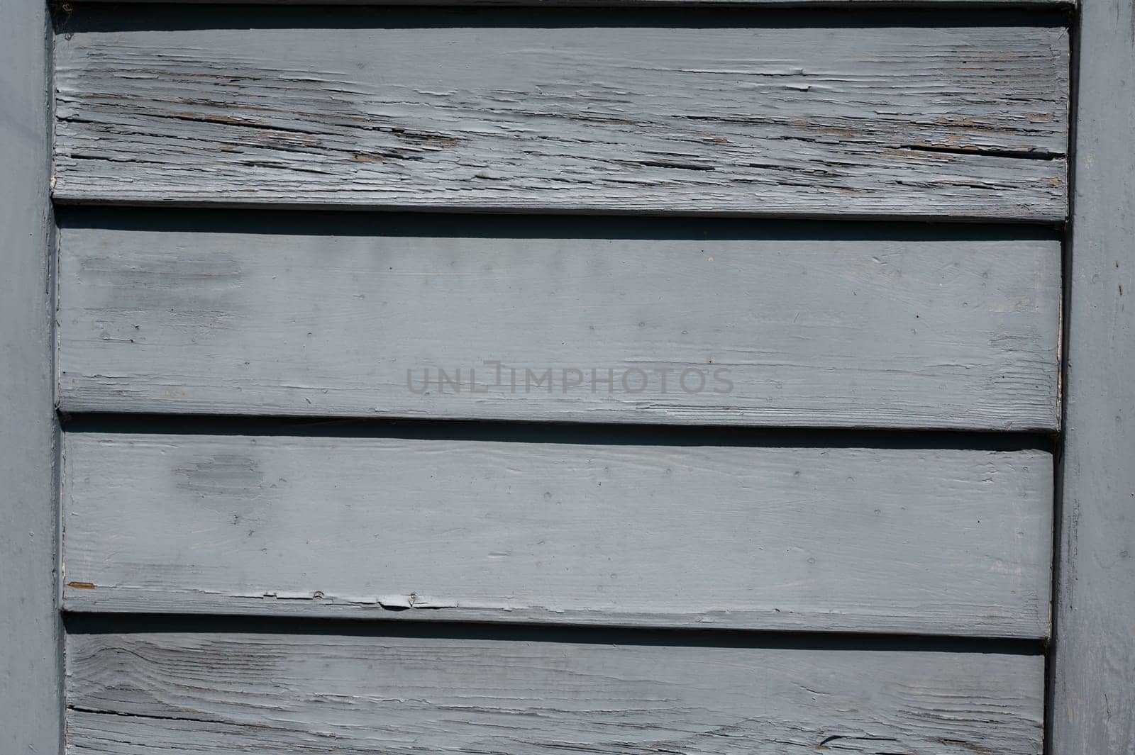 Light blue old wooden slats in the sunlight