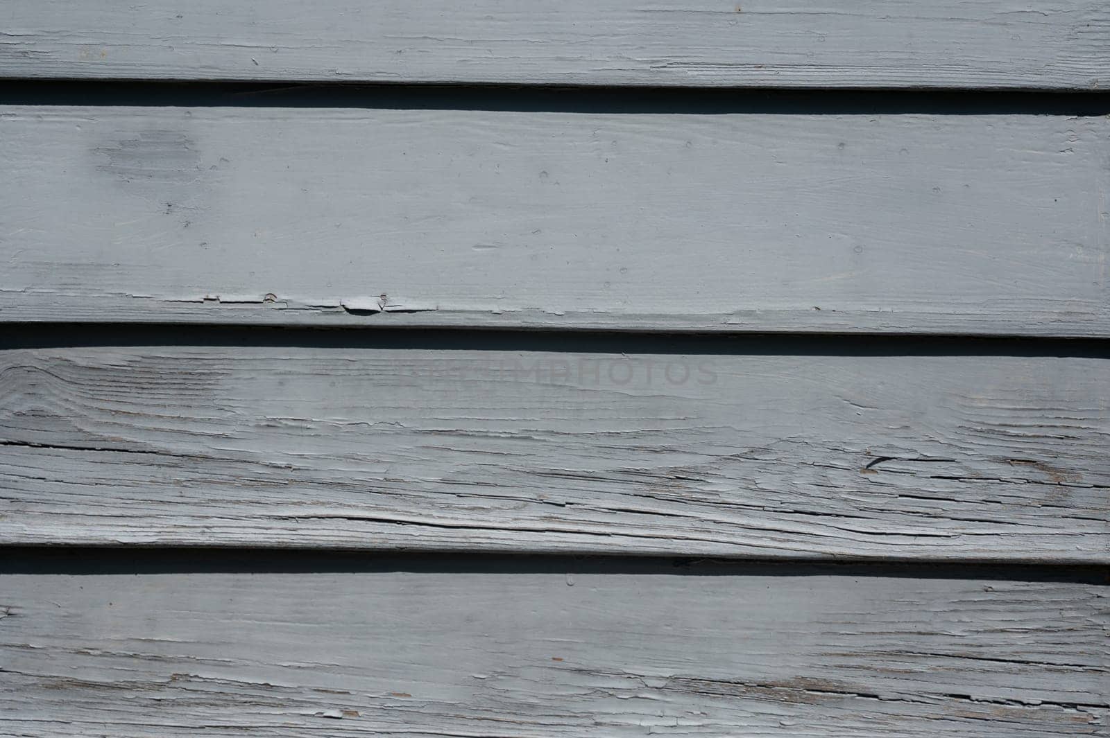 Light blue old wooden slats in the sunlight