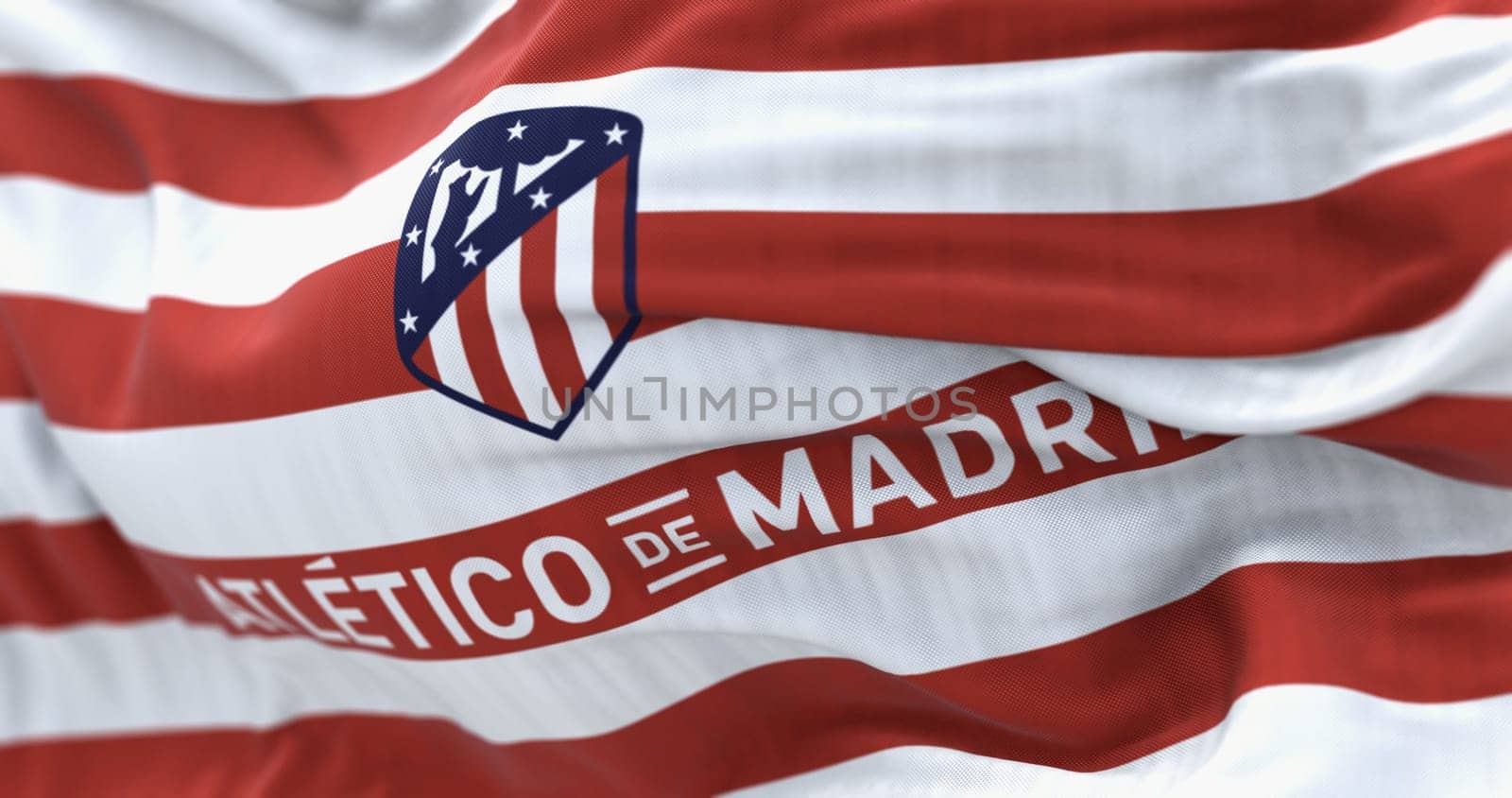 Madrid, Spain, Aug. 1 2023: Close-up of Atletico Madrid waving in the wind. Spanish professional football club based in Madrid. Illustrative editorial 3d illustration render. Selective focus
