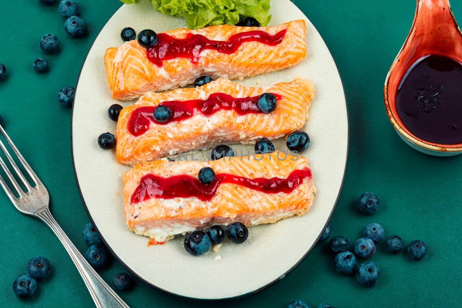Fried salmon fillet with blueberry berry sauce. Healthy food. Space for text.