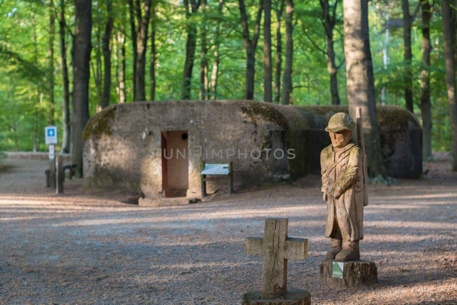 Kapellen, Belgium, May 2023: View on wooden soldier sculpture in Loopgravenpad Mastenbos, part of Flanders Field world war one memorial, in Kapellen, Belgium.