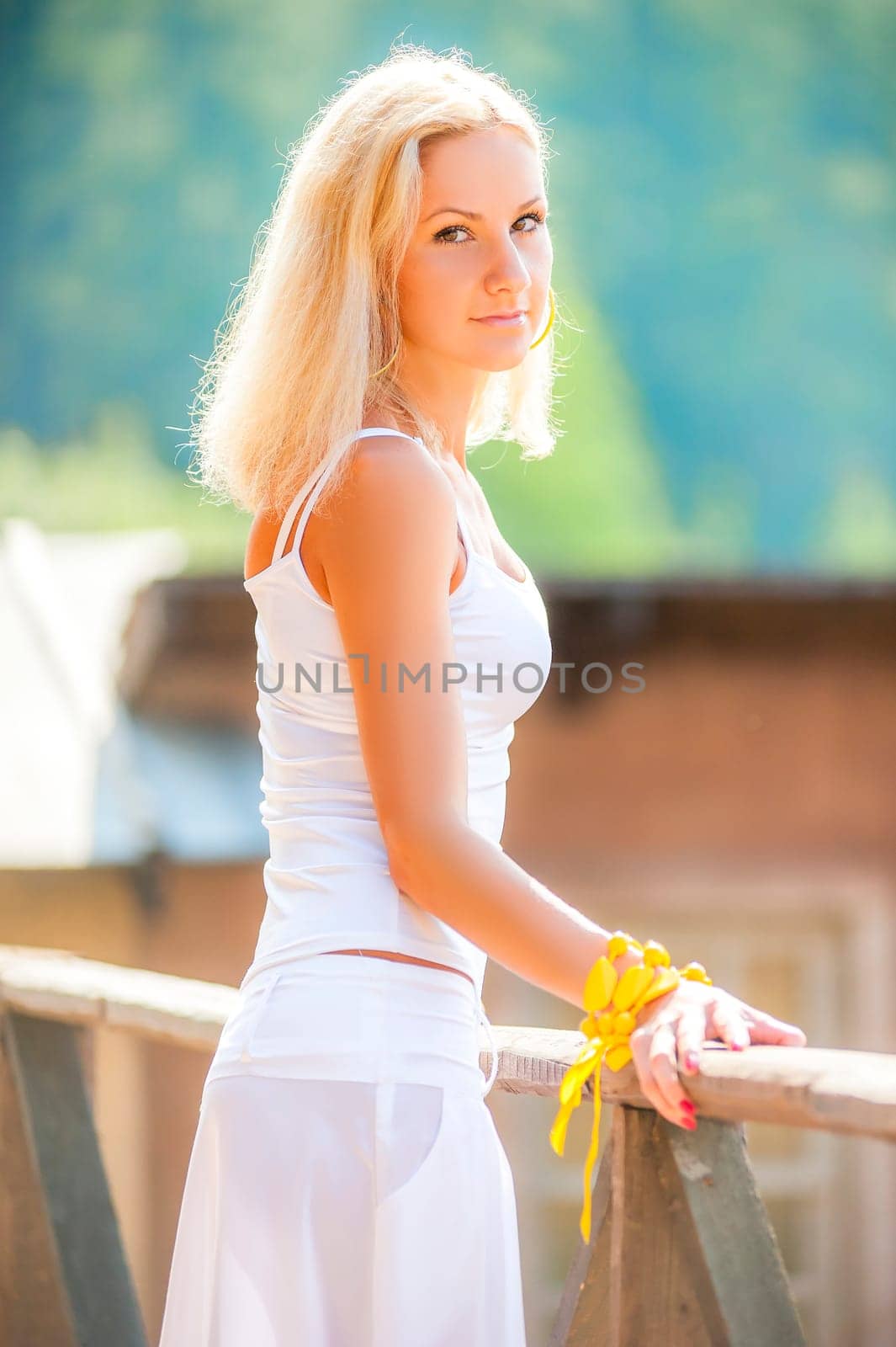 beautiful young girl in a white sundress looking at the camera
