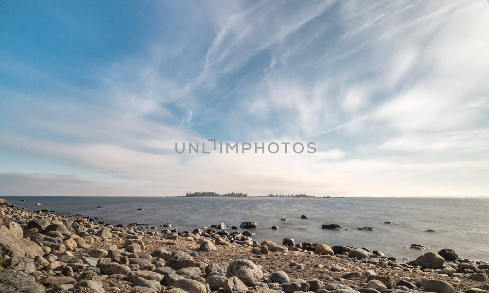 Rocky Shoreline over Ocean with a partly cloudy sky.