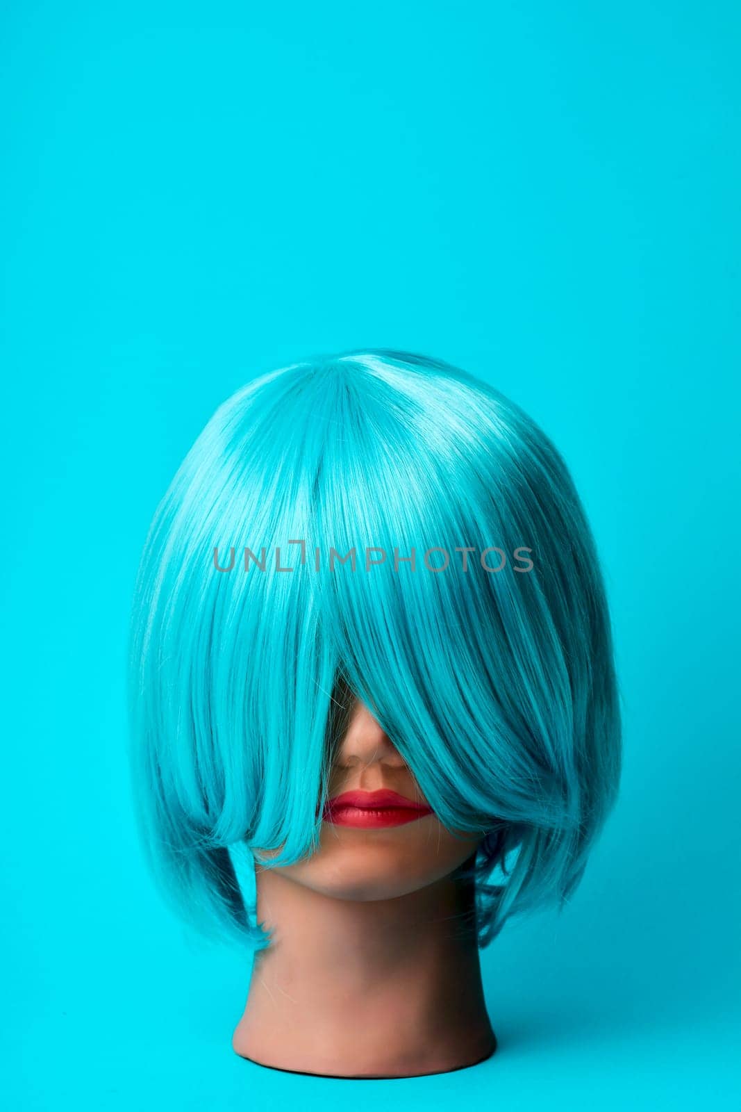 a mannequin head with a blue hair wig on a blue background