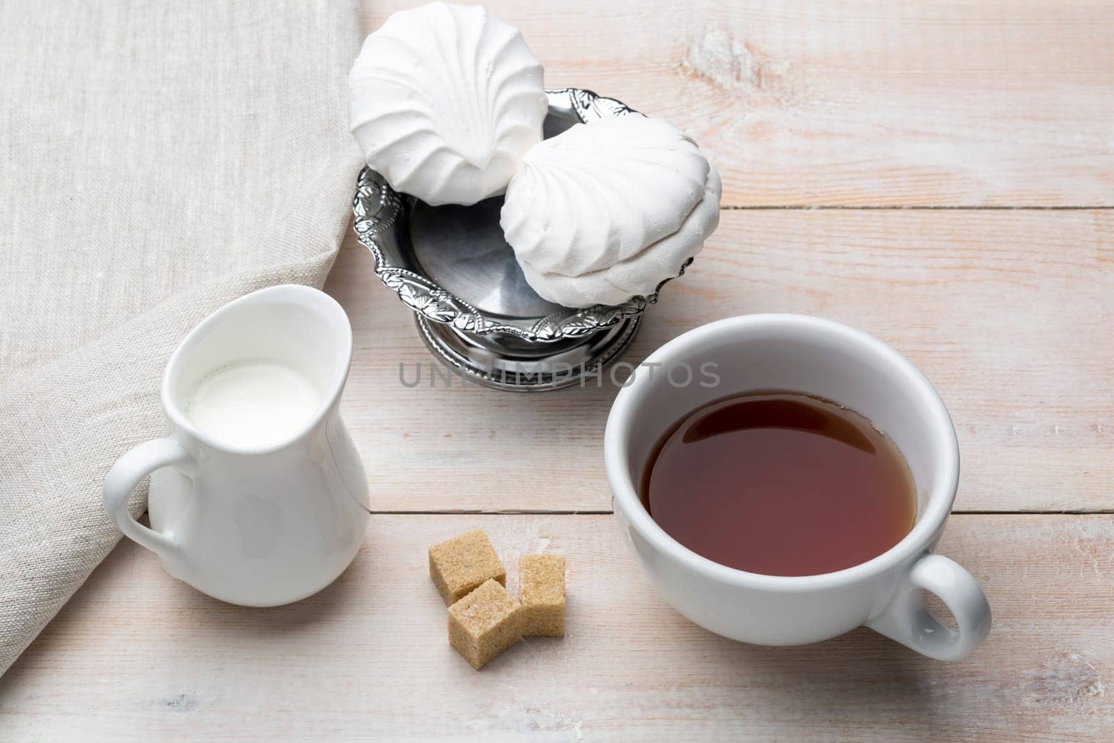 Set of cup black tea and dessert on bright wooden table