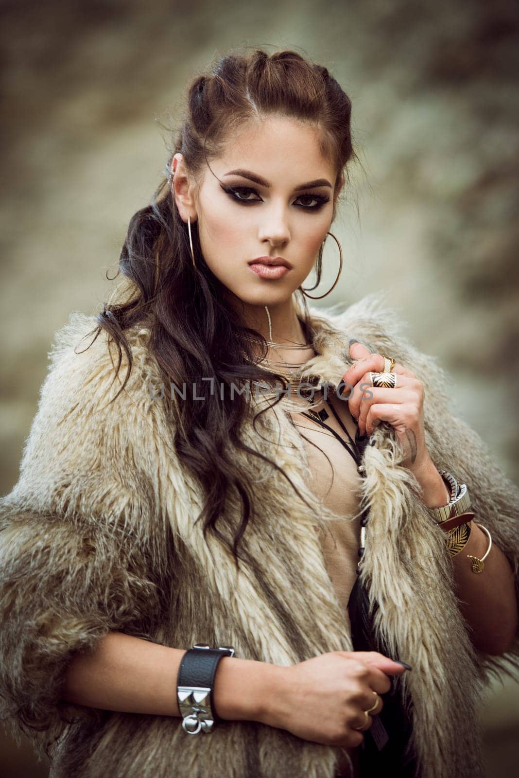 Portrait of a beautiful lady with flash tottoos posing outdoors near the sea