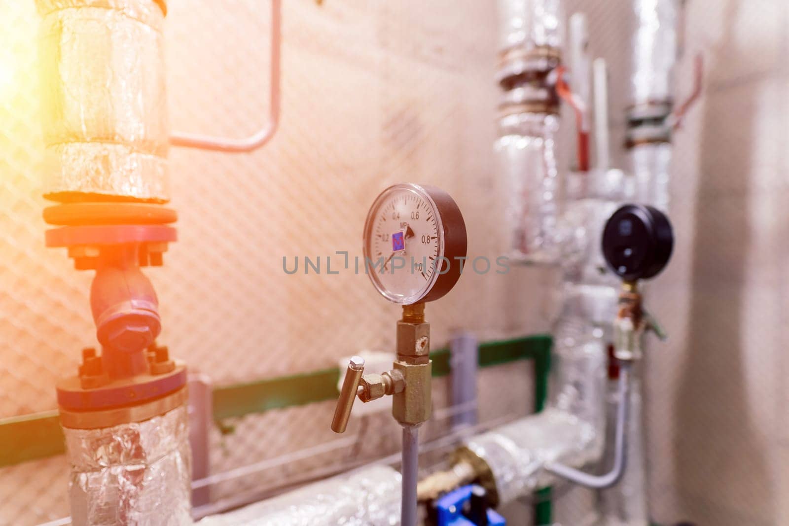 Pressure sensor in an industrial boiler room. Barometer in a heating system. Close-up.