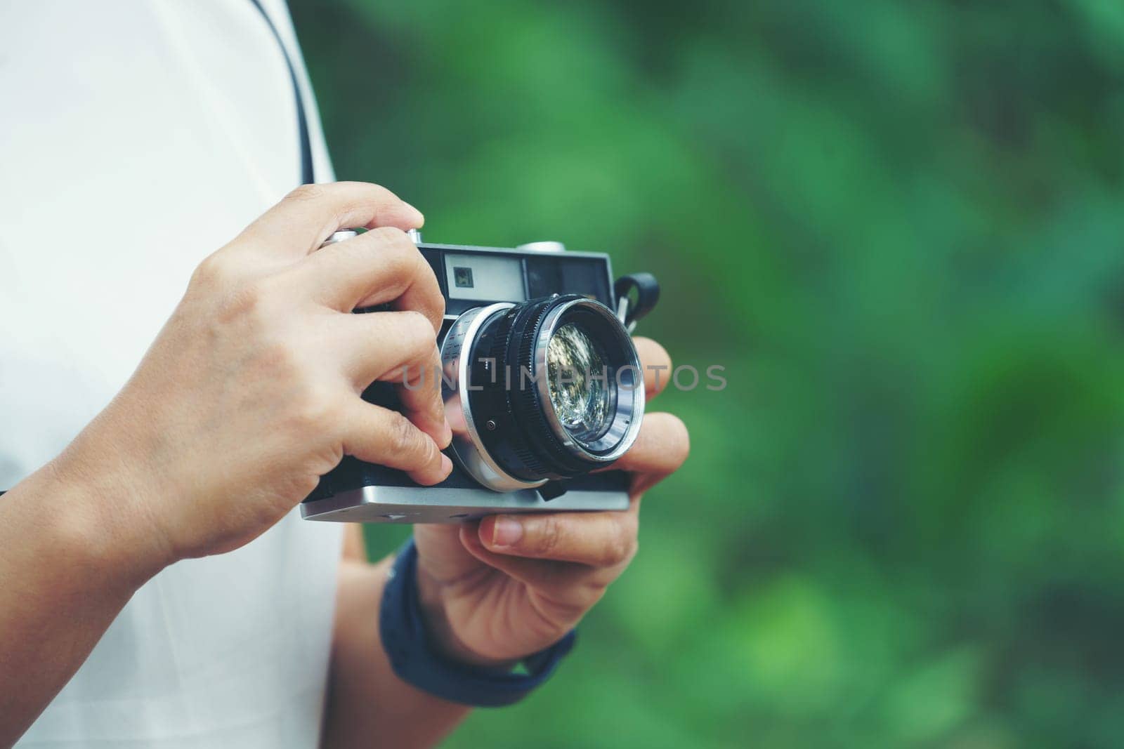 woman with vintage camera in park
