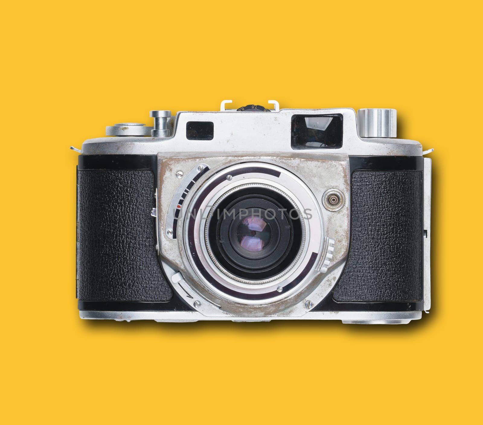 vintage old film camera on yellow background with shadow