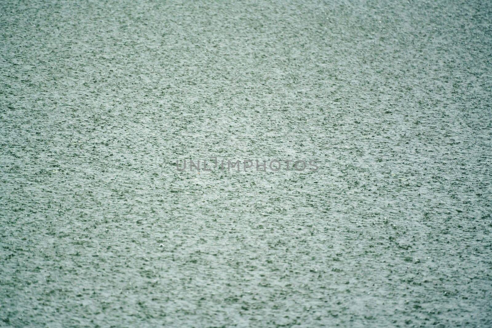 heavy rain hitting the water surface