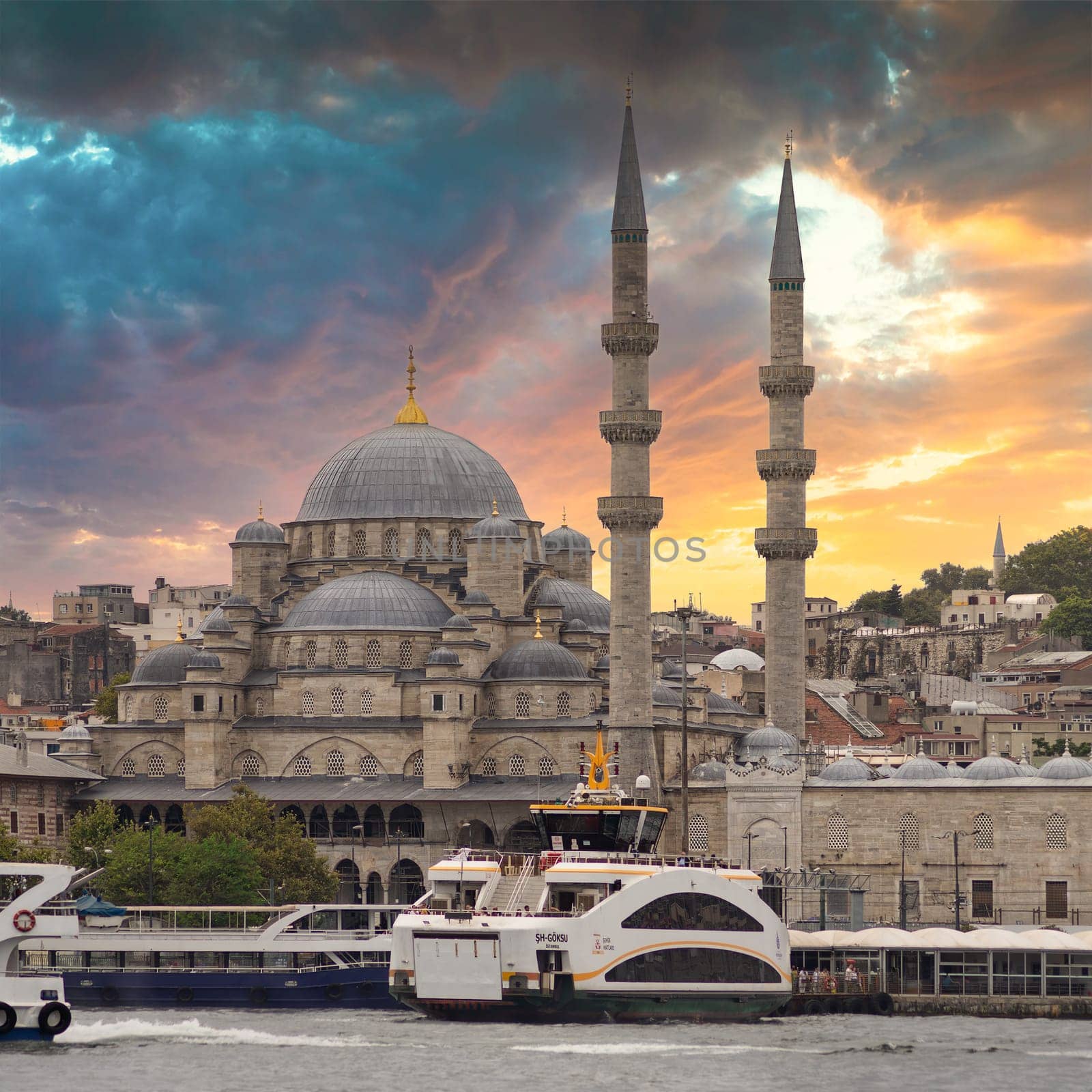 Istanbul city view from Galata Bridge at Eminonu overlooking the Golden Horn with ferries, ferry terminals, and Rustem Pasha Mosque before sunset, Istanbul, Turkey