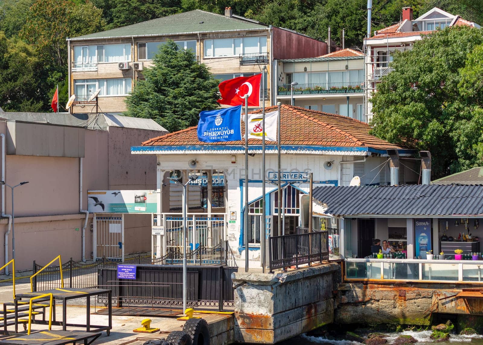 Istanbul, Turkey - August 29, 2022: Bosphorus Strait, Sariyer Ferry Terminal with dense green trees in the background