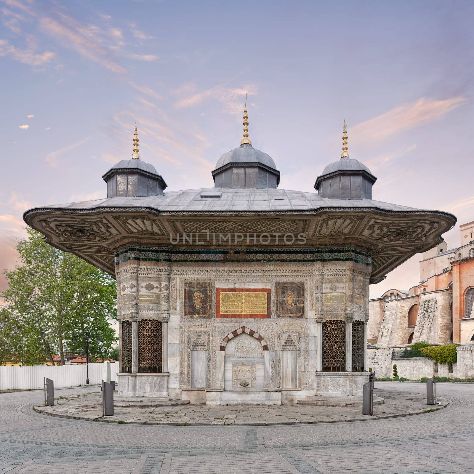 Fountain of Sultan Ahmed III, aka Ahmet Cesmesi, a 17th century public Turkish rococo water fountain, or Sabil, located in the Great Square, near the Imperial Gate of Topkapi Palace, Istanbul, Turkey