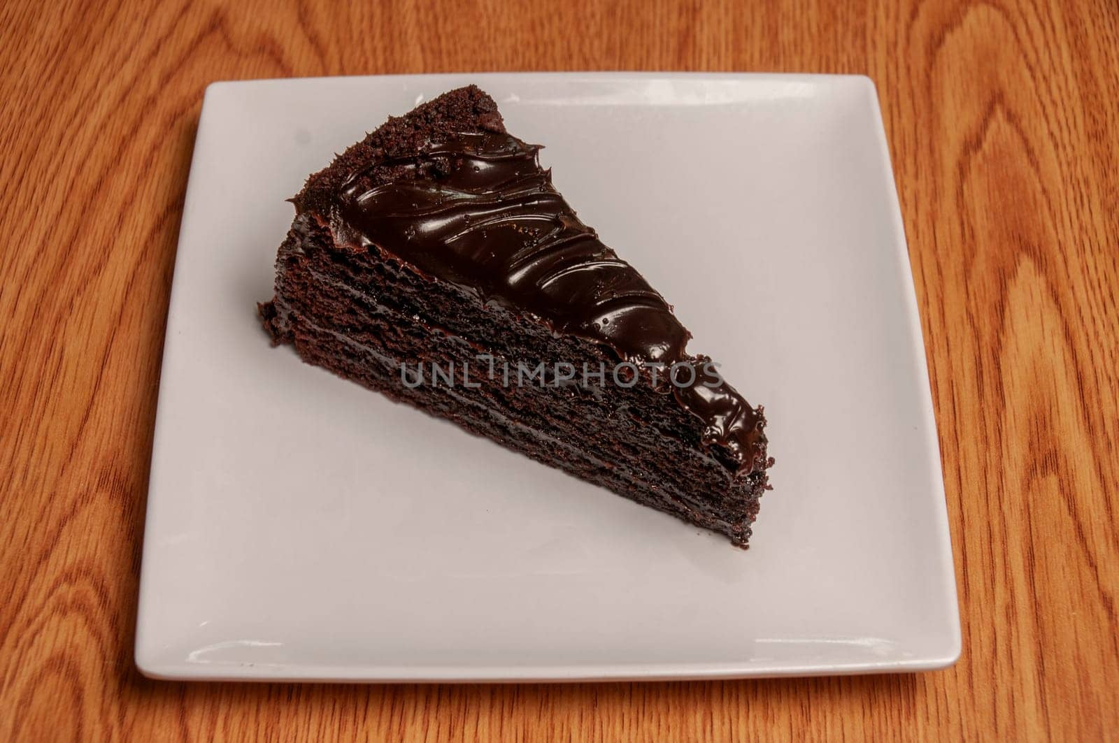 Piece of decadently delicious traditional chocolate fudge cake.