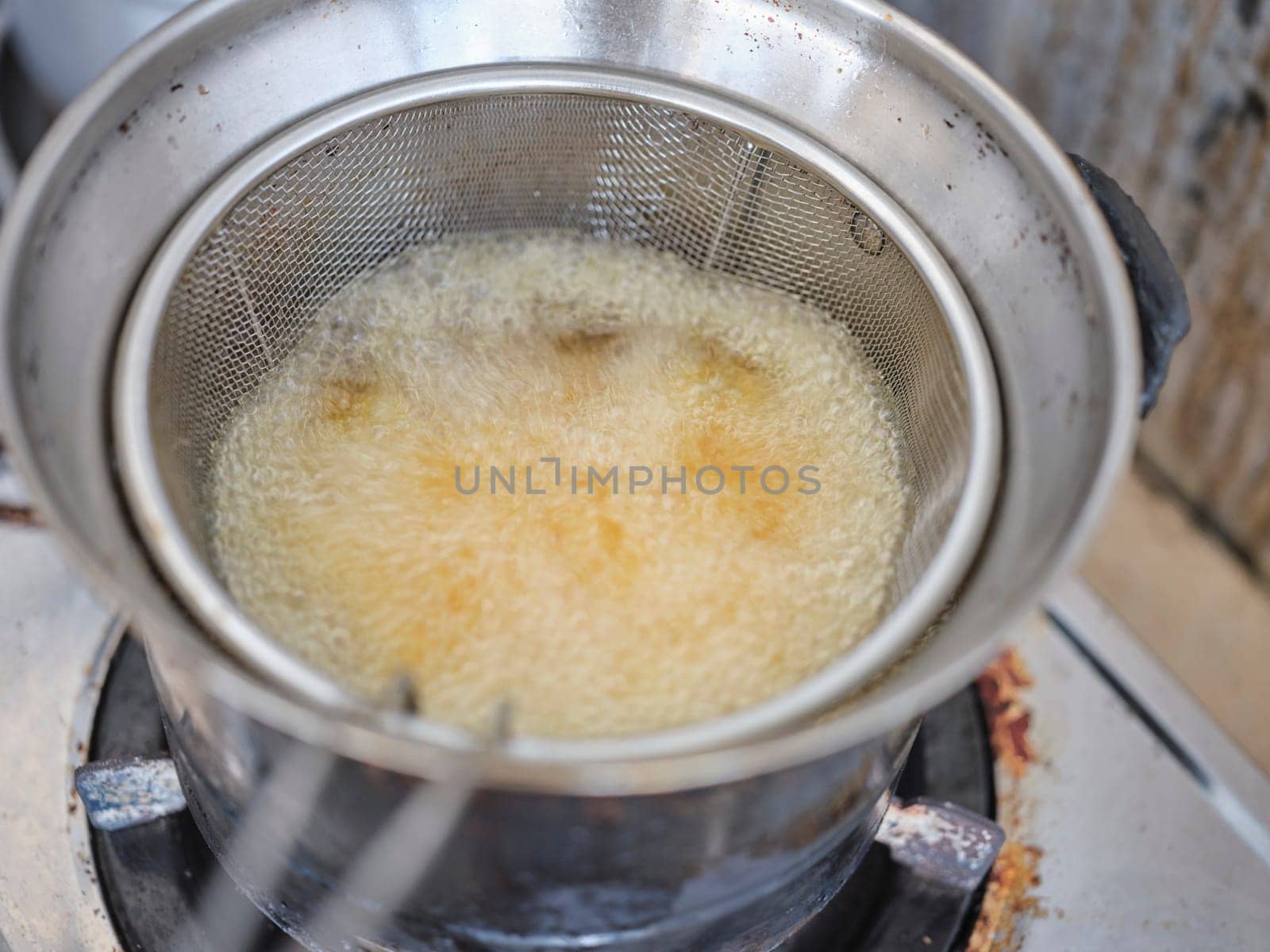 French fries in a deep fryerin hot oil . Preparation of french fries. FAST food